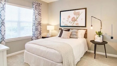 Carpeted bedroom with baseboards