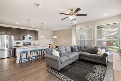 Living area with a ceiling fan, recessed lighting