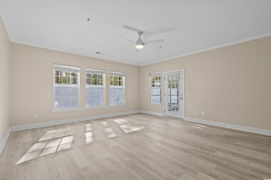 Empty room with crown molding, plenty of natural l