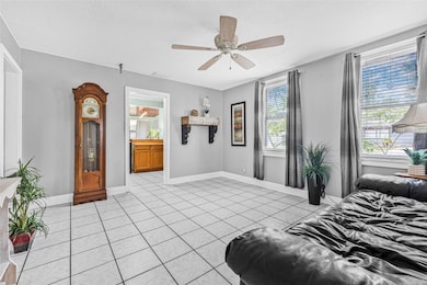 Spacious living room features tile flooring and a beautiful mantel, creating a warm and welcoming atmosphere.