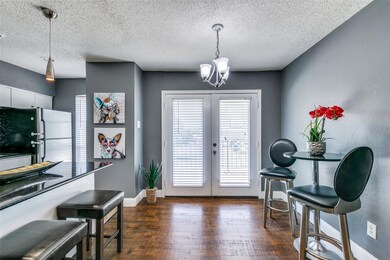 Dining area has a decorative light fixture, breakf