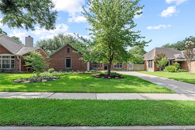 Manicured landscaping, mature trees, and a lush gr