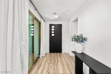 Foyer with front patio doors and guest suite entra