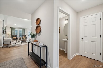 Hallway featuring light wood finished floors and baseboards