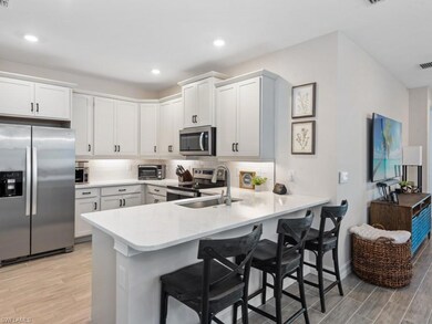 Kitchen with a peninsula, a breakfast bar, applian