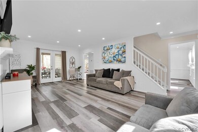 Living room with french doors, ornamental molding,