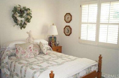 1ST BEDROOM WITH PLANTATION SHUTTERS.