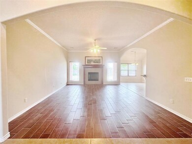 Unfurnished living room featuring ornamental moldi