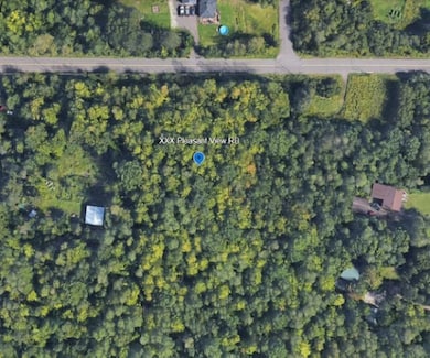 Aerial overview of property's location featuring a heavily wooded area