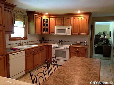 Kitchen Distressed maple cabinets with ceramic tile floor