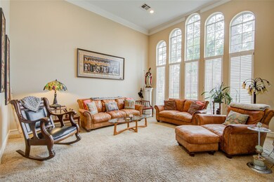 Fabulous windows create a bright formal living room. Imagine how tall your Christmas tree will be in this amazing space.