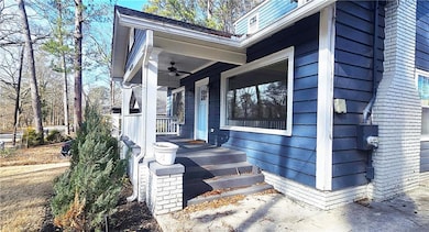 Entrance to property featuring ceiling fan