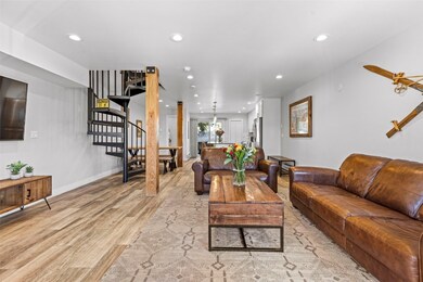 Living area with light wood-type flooring, stairwa