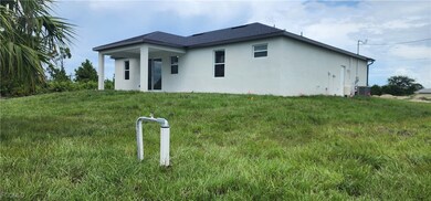 Rear view of property with stucco siding