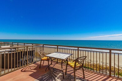 Balcony featuring a water view and a beach view