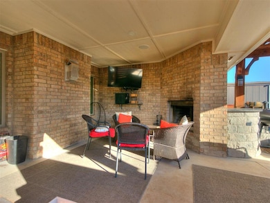 View of patio featuring an outdoor brick fireplace