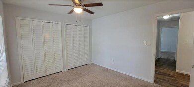 Unfurnished bedroom featuring baseboards, multiple closets, ceiling fan, and carpet flooring