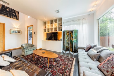 Living area featuring baseboards, built in shelve