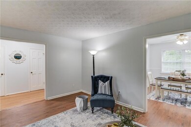 Living area with a textured ceiling, wood finished