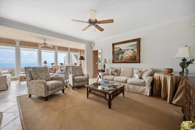 Tiled living room with ornamental molding and ceil