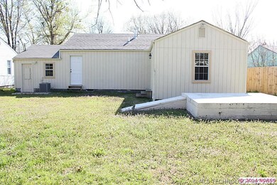 back view of house showing storm shelter with elec