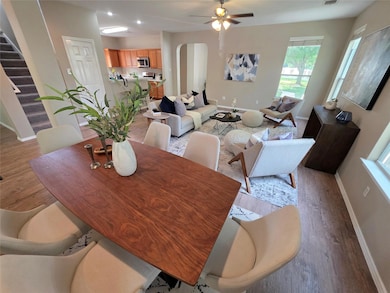 Dining room with light wood-type flooring, arched
