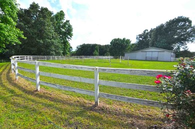 The 4 or 5-stall barn features a tack room and hay