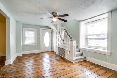 Hardwood floored foyer featuring ceiling fan
