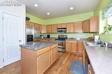 Large open kitchen, with hard wood flooring, and c