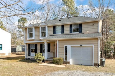Front facade with a garage, a storage unit, and a