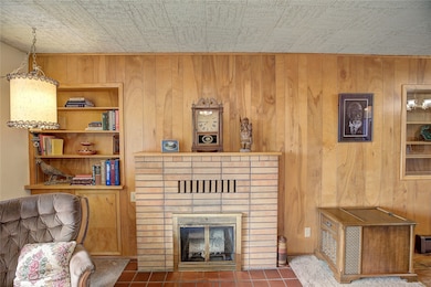 Living Room 4 - natural woodburning fireplace with storage to left
