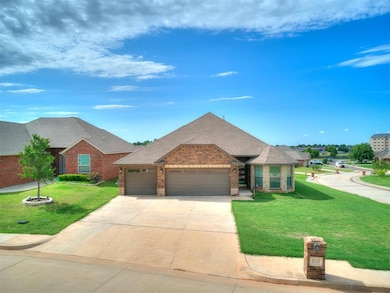 View of front of property with brick siding, an attached garage, driveway, roof with shingles, and a front yard