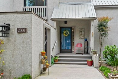 Doorway to property with a balcony, metal roof, st