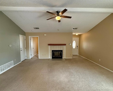 Unfurnished living room with a ceiling fan, a tex