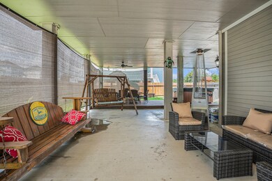 spacious covered patio with wooden swings, cushion