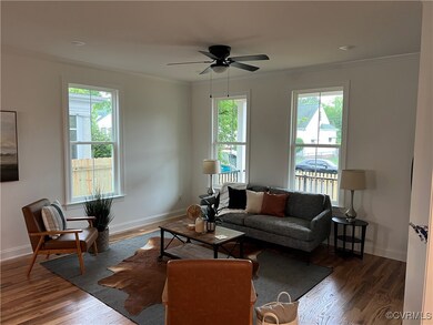 Living area with ornamental molding, wood finished