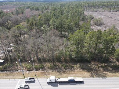 Aerial view featuring a wooded view