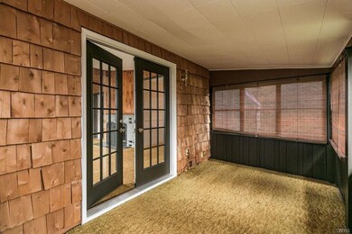Side enclosed porch off living room area.