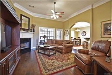 THE LIVING AREA FEATURES A FIREPLACE,  CROWN MOLDI