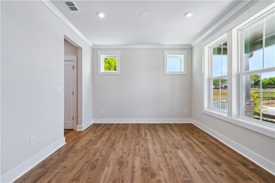Spare room with baseboards, visible vents, and cro