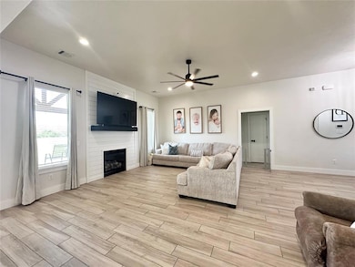 Living room with light hardwood / wood-style floor