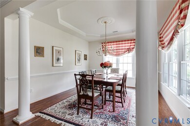 Dining Room with Hardwood Floors, Tray Ceiling and Chair Rail.