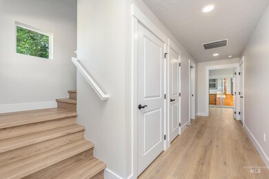 Hall featuring stairway, light wood-style floors, and recessed lighting