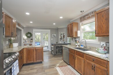 Large Eat-In Kitchen. Granite Counters. SS Appliances. View from entry to Dining Room Area. Leads to Living Room Area and Large Deck on Rear.