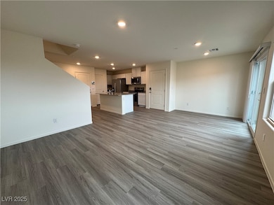 Unfurnished living room featuring dark wood-type f