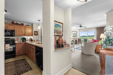 Kitchen featuring black appliances, brown cabinets, light tile patterned flooring, light colored carpet, and light stone countertops