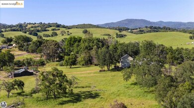 Aerial view featuring a rural view and a mountain view