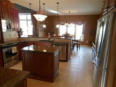 Kitchen kitchen includes appliances, custom wood c