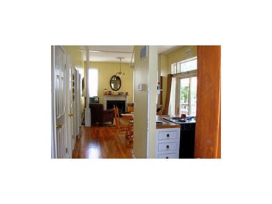 Wood floors and 10 ft ceilings create an open livi
