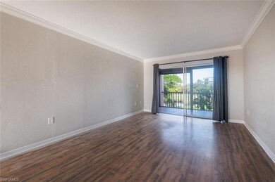 Unfurnished room with ornamental molding and dark 